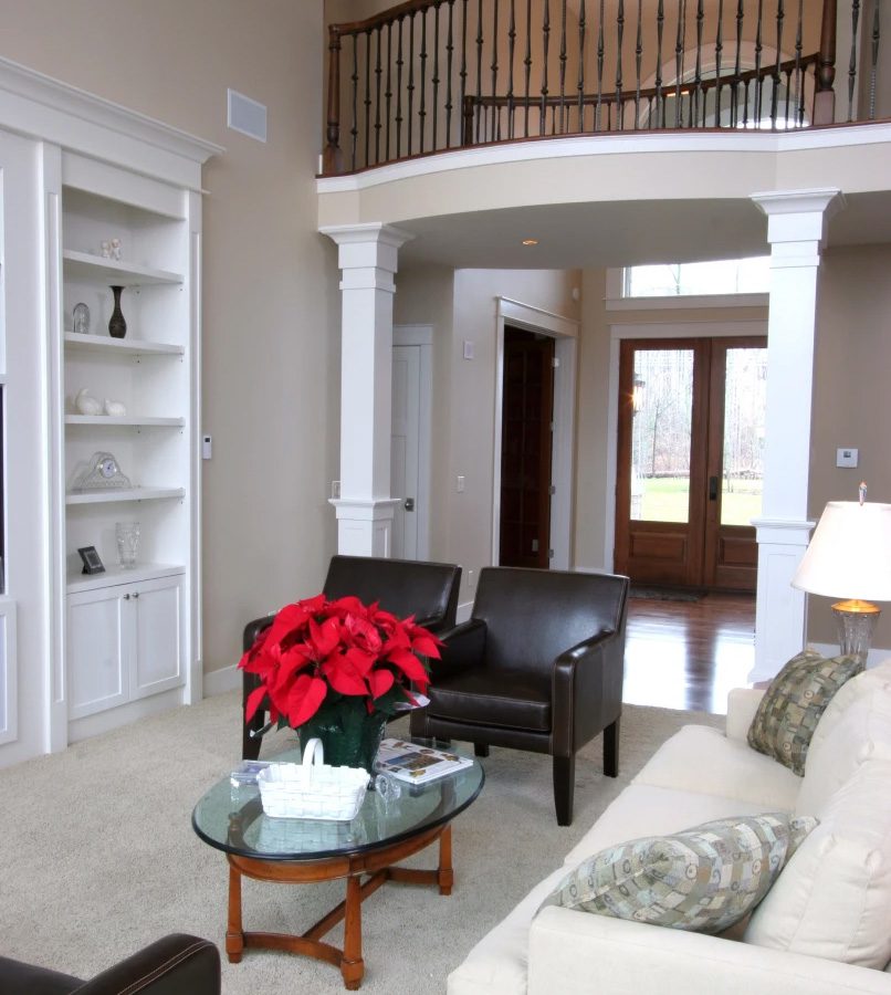 Elegant living room with red poinsettia centerpiece.