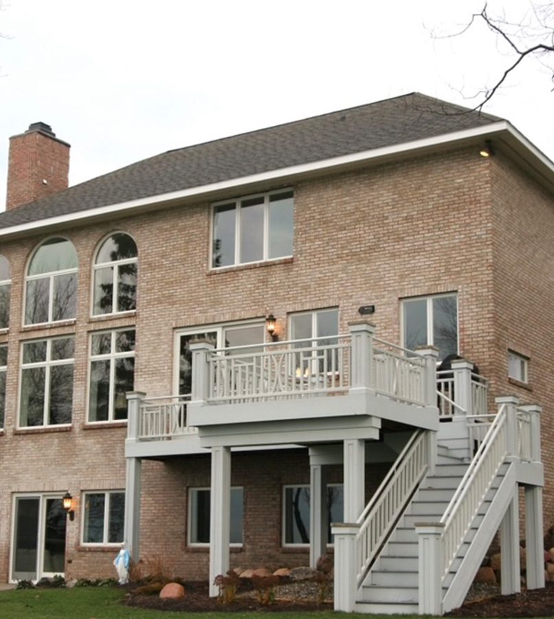 Brick house with a balcony and stairs.