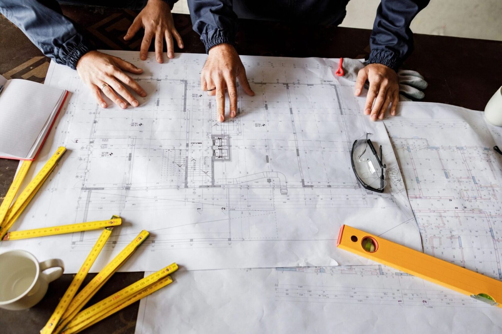 Architects reviewing construction plans with tools