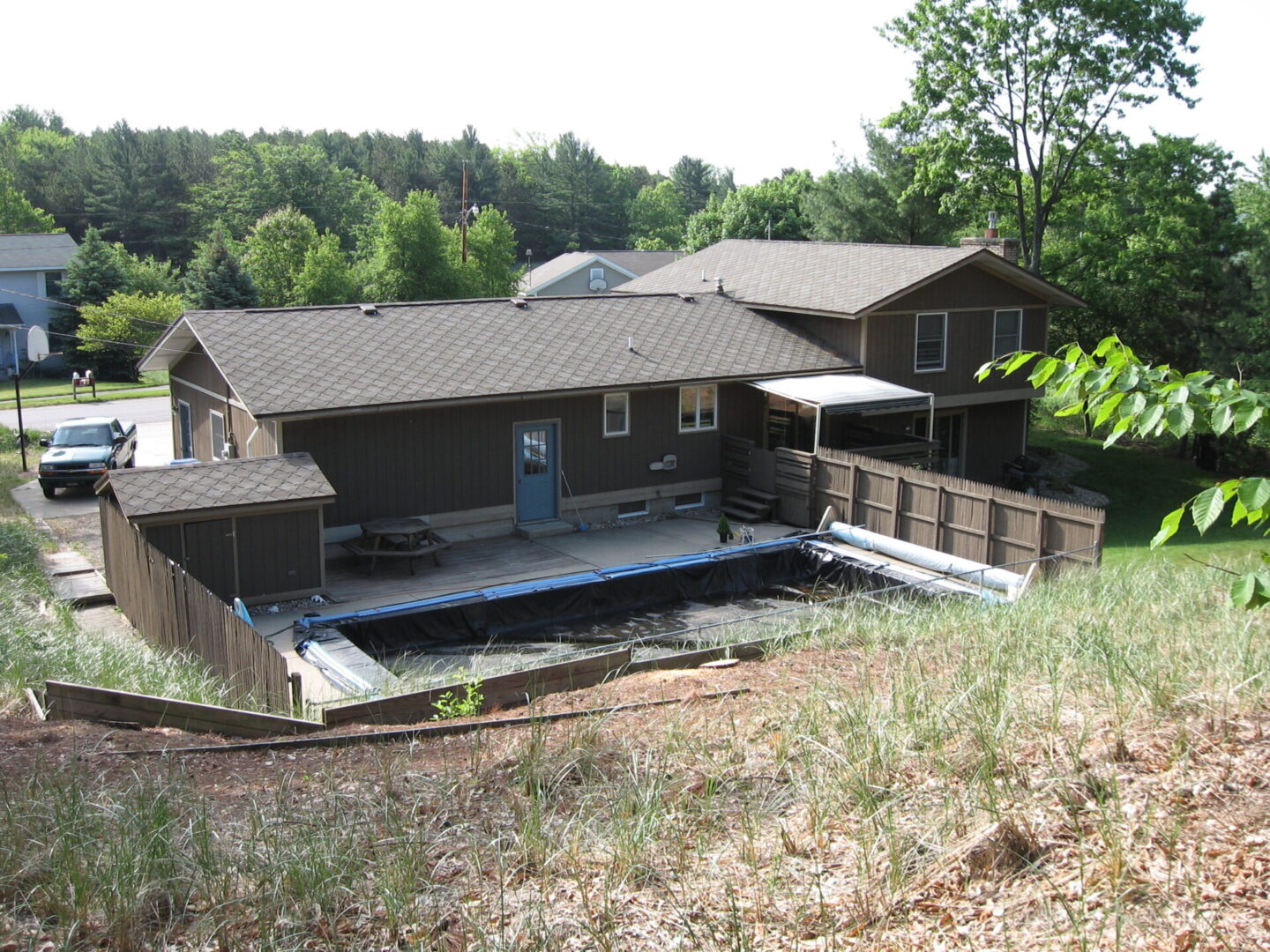 House with fenced backyard and covered pool.