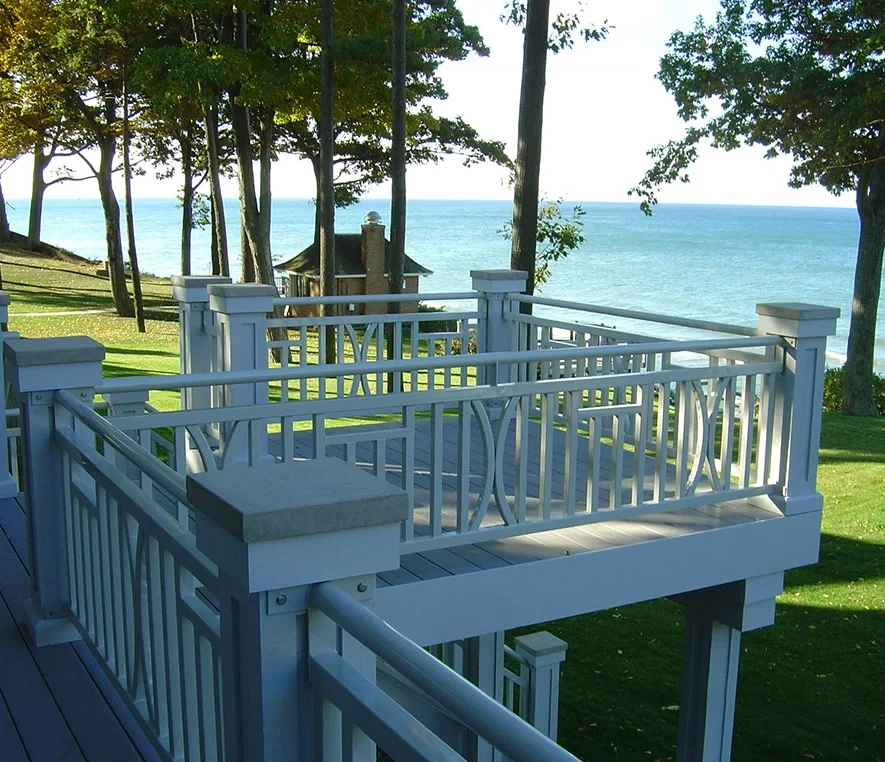 Deck overlooking lake with trees and gazebo.