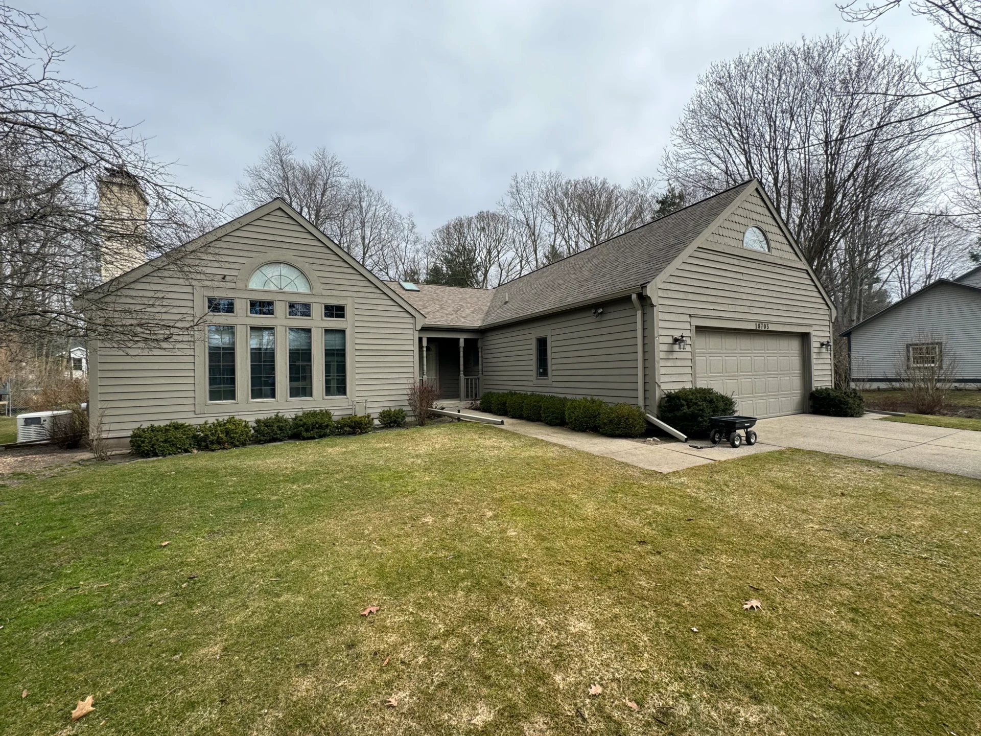 Single-story house with large front lawn.