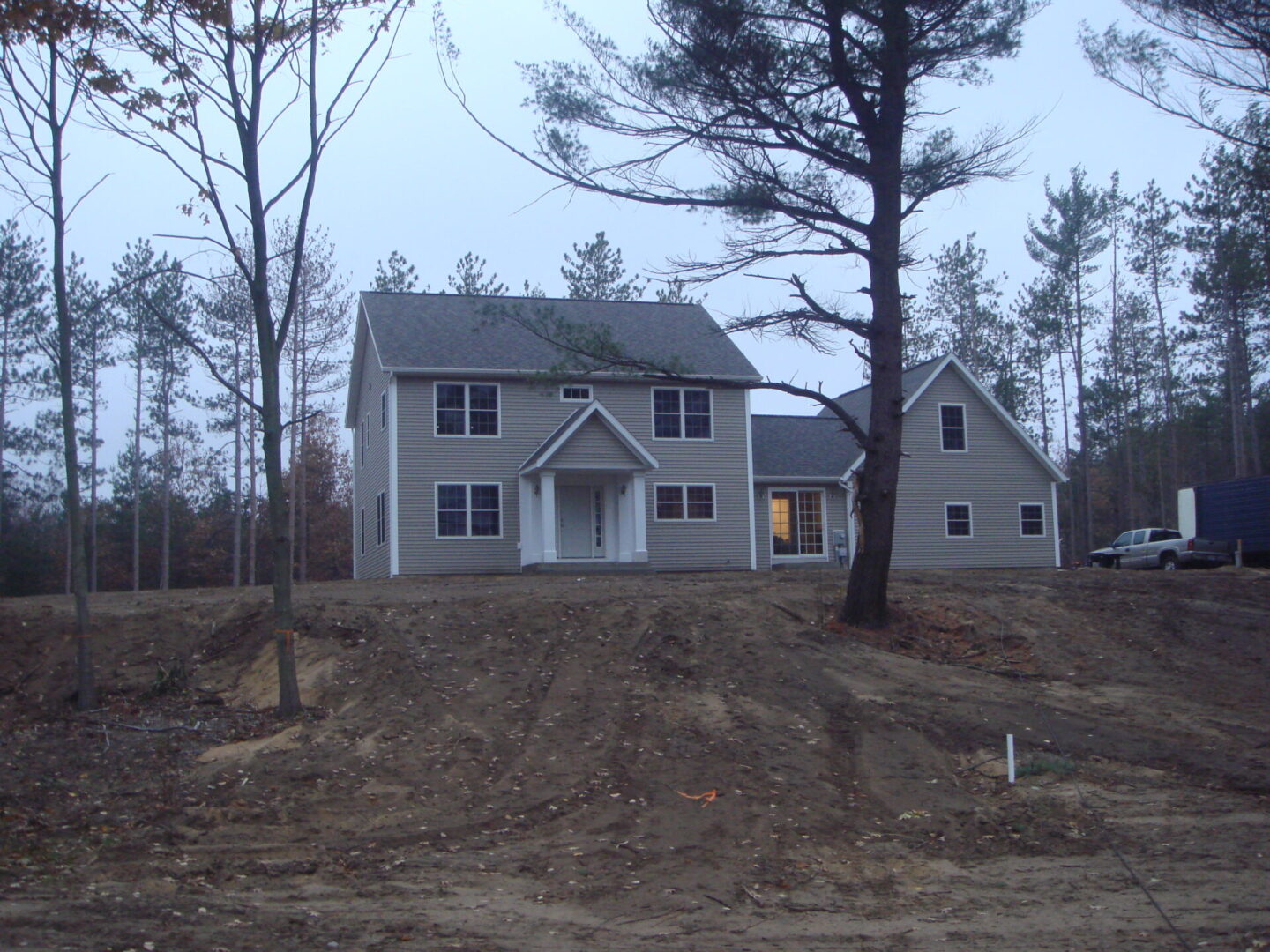 Two-story house surrounded by trees.