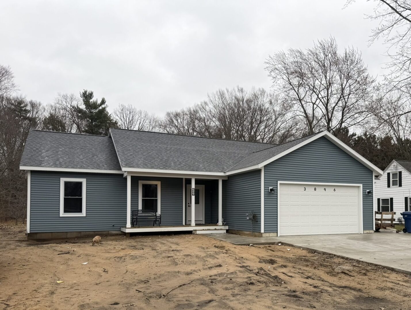 Blue single-story house with attached garage.