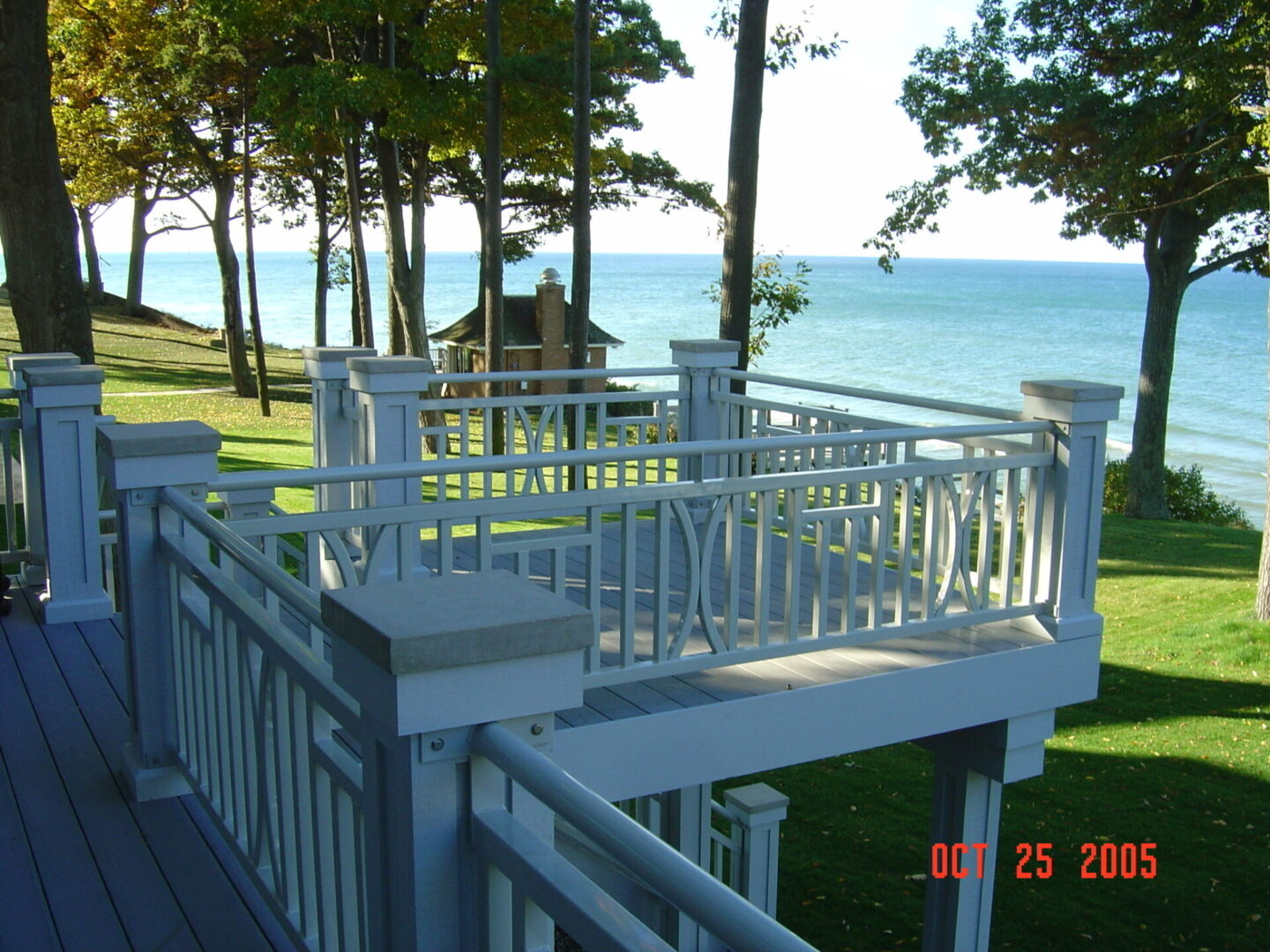 Deck overlooking trees and lake view.