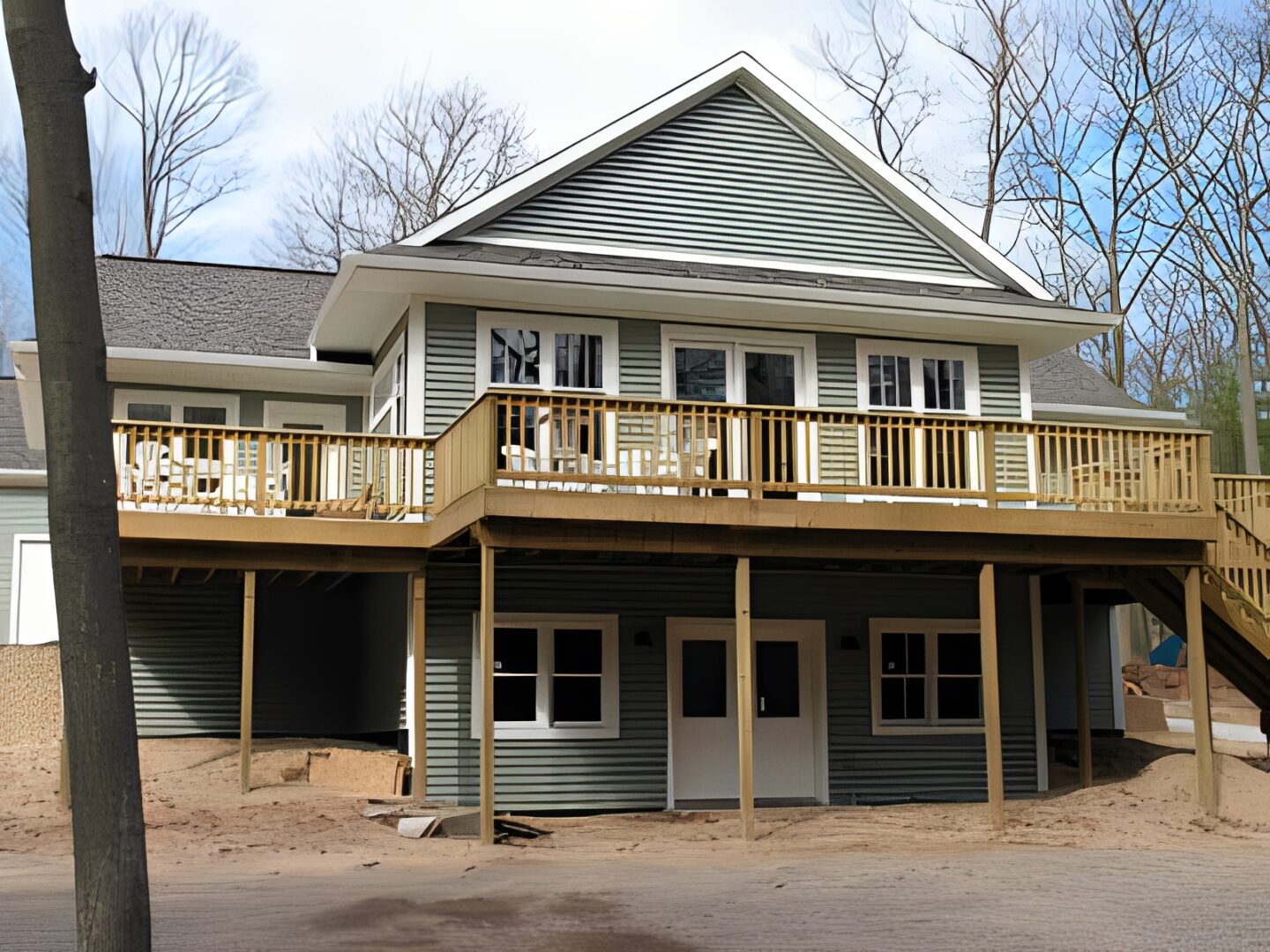 Two-story house with wooden deck.